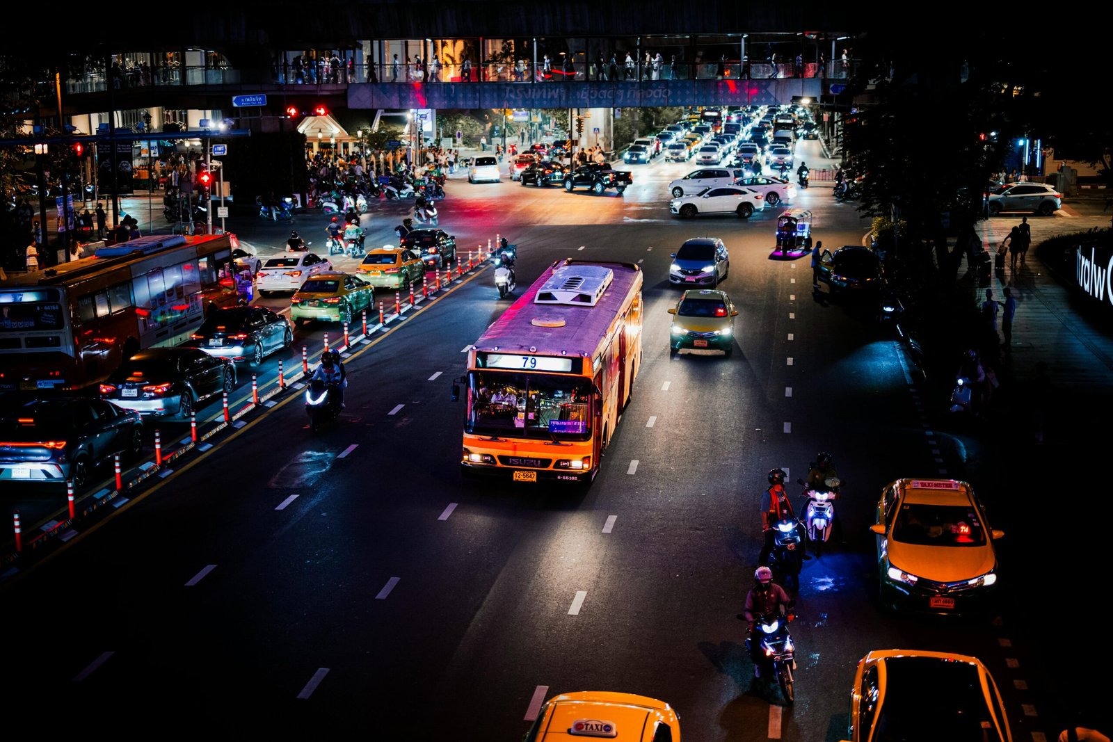 A bustling urban street at night with vibrant traffic and city lights, showcasing lively city nightlife.