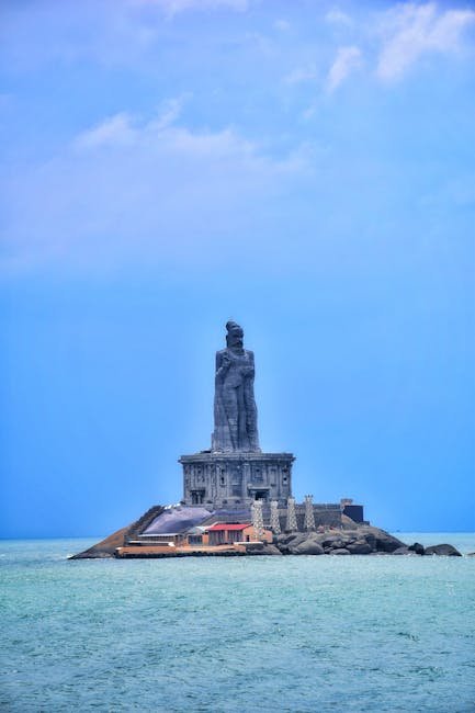 Majestic view of the Thiruvalluvar Statue in Kanyakumari, India, surrounded by serene sea waters.